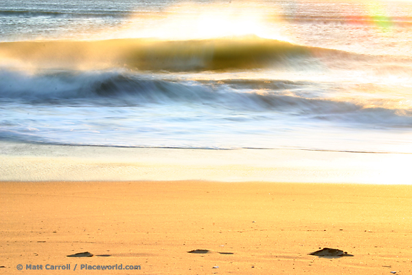 breaking ocean wave with offshore winds and glowing sunshine