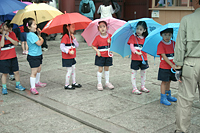 Schoolkids with colorful umbrellas