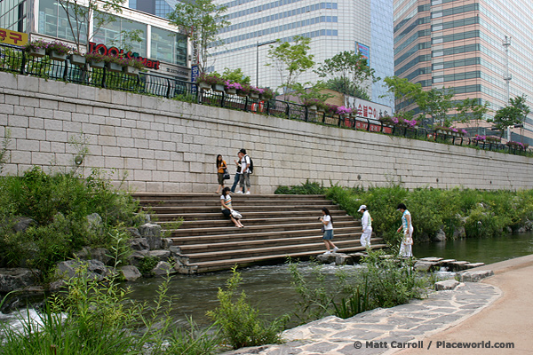 parklike river in city with people