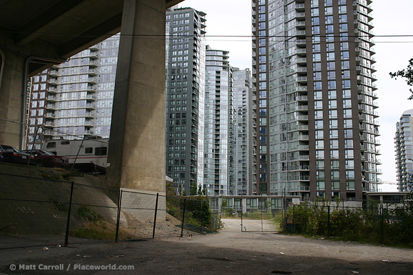 Vehicles parked near new housing towers