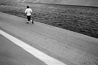 Runner along Santa Ana River, Fountain Valley, California