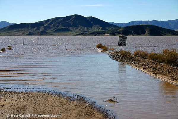 desert lake with partially-submerged road sign