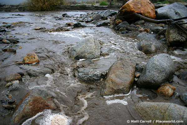 swollen desert creek during storm