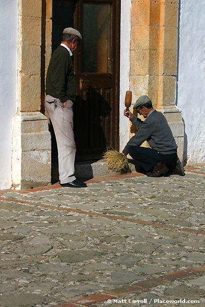 two older men outside a church in a Pueblo Blanco