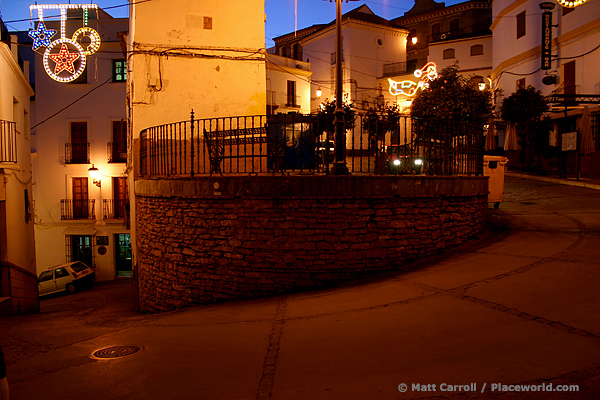 steep, meandering street in the Spanish town of Setenil at twilight